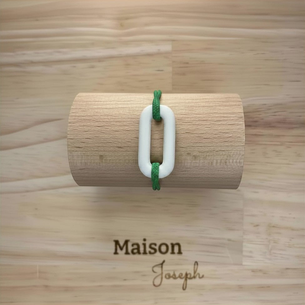 Maison Joseph white ceramic link bracelet on adjustable green sport cord.