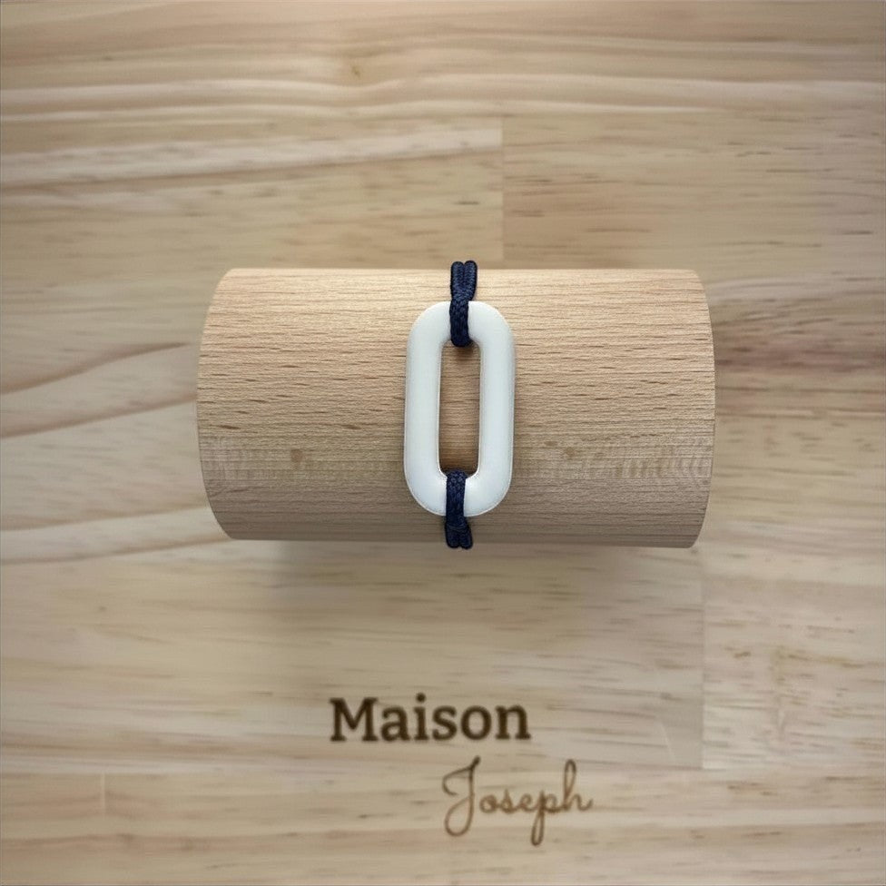 Maison Joseph white ceramic oval link bracelet on adjustable navy sport cord.